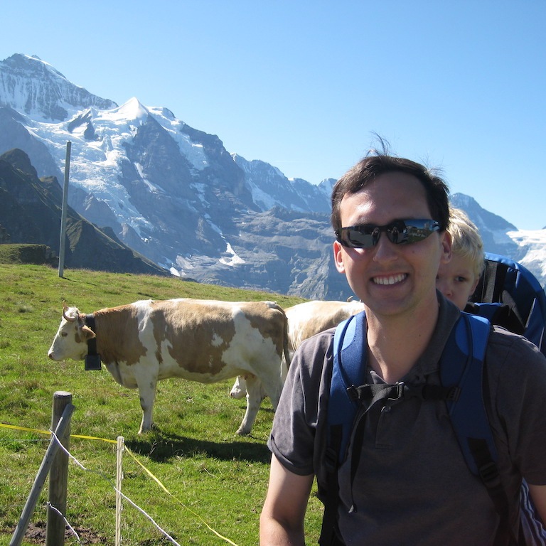 Dad and son enjoying the cows in the Jungfrau Region of Switzerland.
